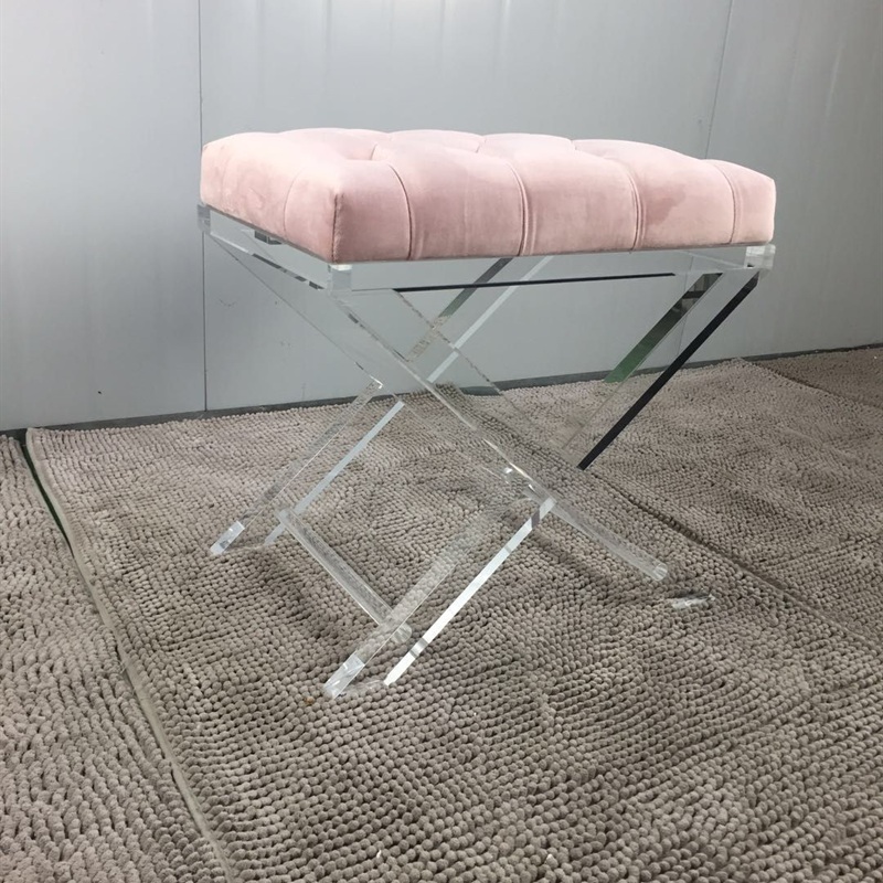 Pink upholstered acrylic X frame bench
