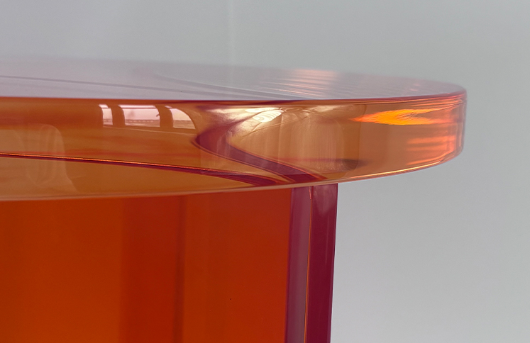 Polished rounded edge on amber acrylic table top, premium edge finishing for colored acrylic furniture wholesale