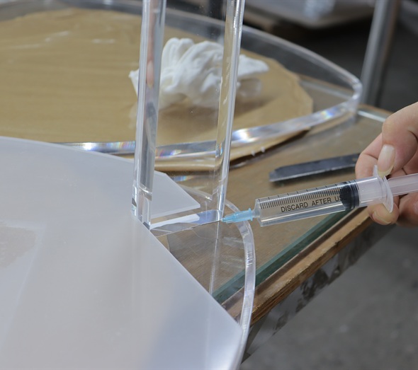 Precision adhesive bonding of clear acrylic component