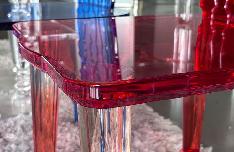 Red acrylic table with transparent legs