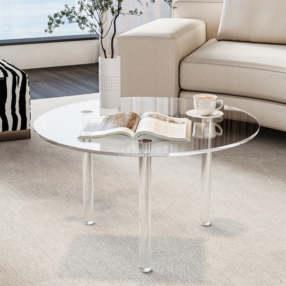 Round clear acrylic coffee table with cylinder legs in living room