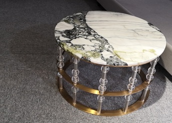 Round marble coffee table with beaded acrylic legs and brass rings