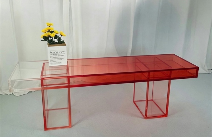 Translucent red acrylic bench with pull out drawer and flowers