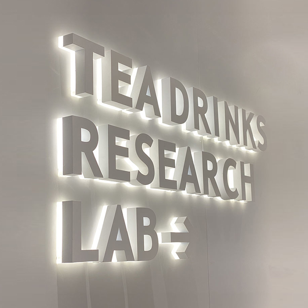 custom white acrylic backlit 3d letters for a beverage research laboratory wall
