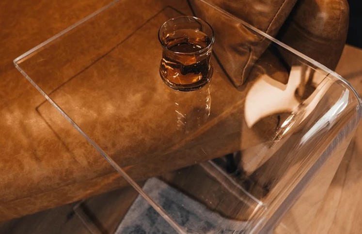 clear-acrylic-coffee-table-on-leather-sofa