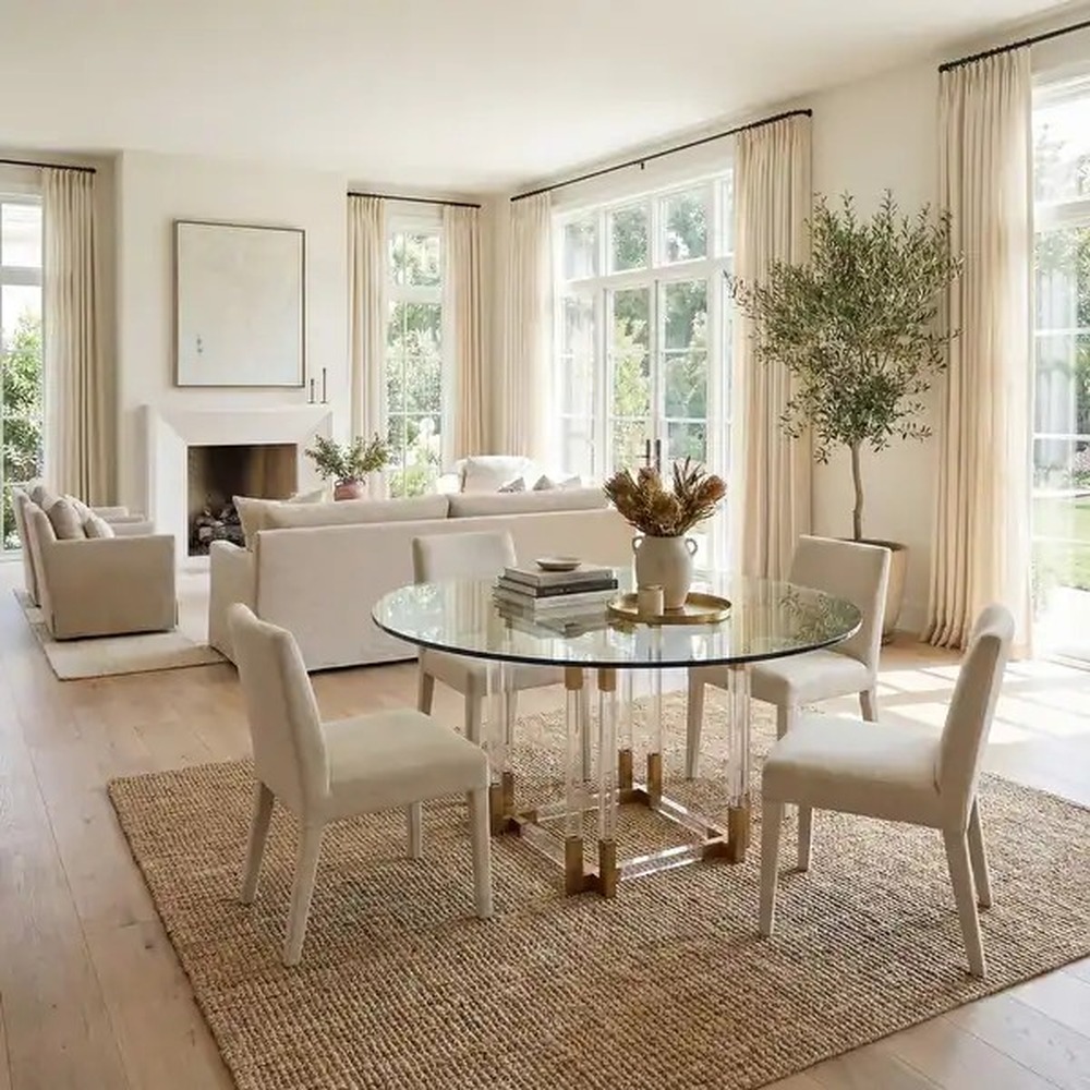 round-glass-dining-table-acrylic-legs-brass-accents